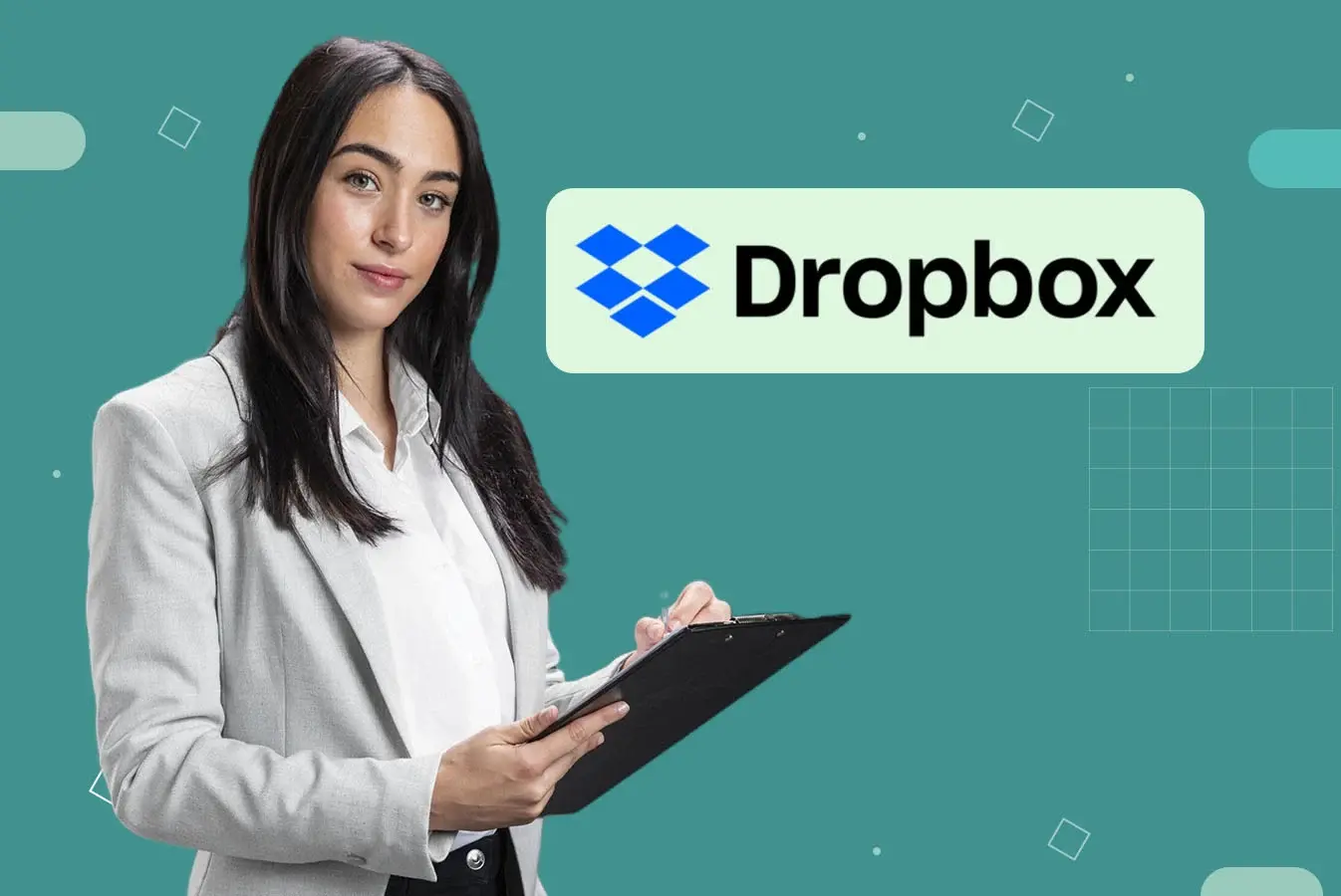 A woman holding a table pc standing beside Dropbox logo