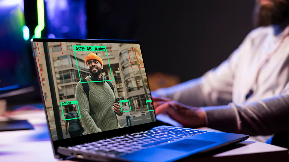 Laptop screen with a photo of a person for analytics