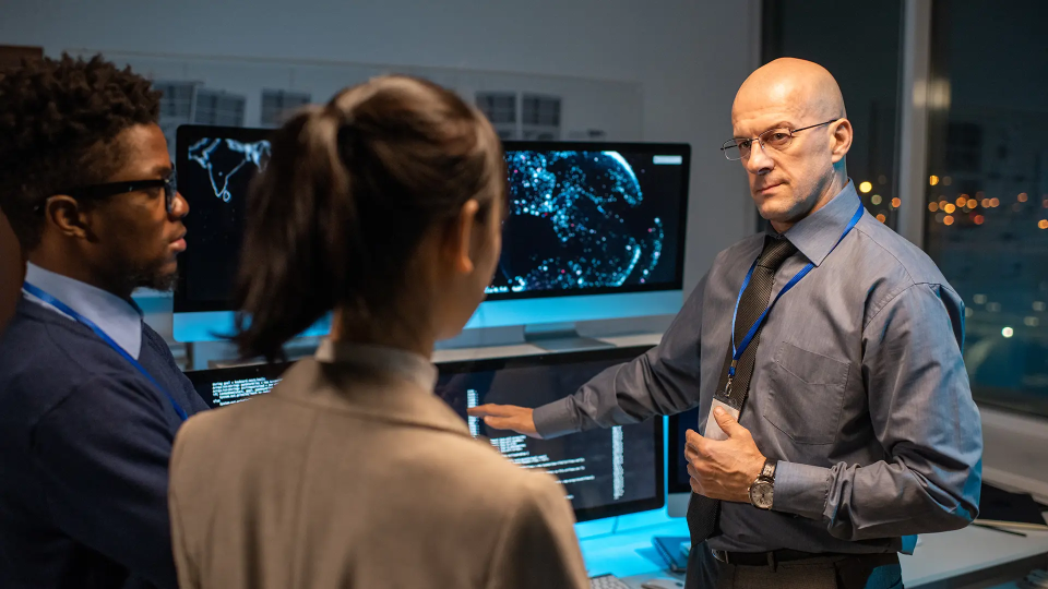 two persons listening to a inspection officer