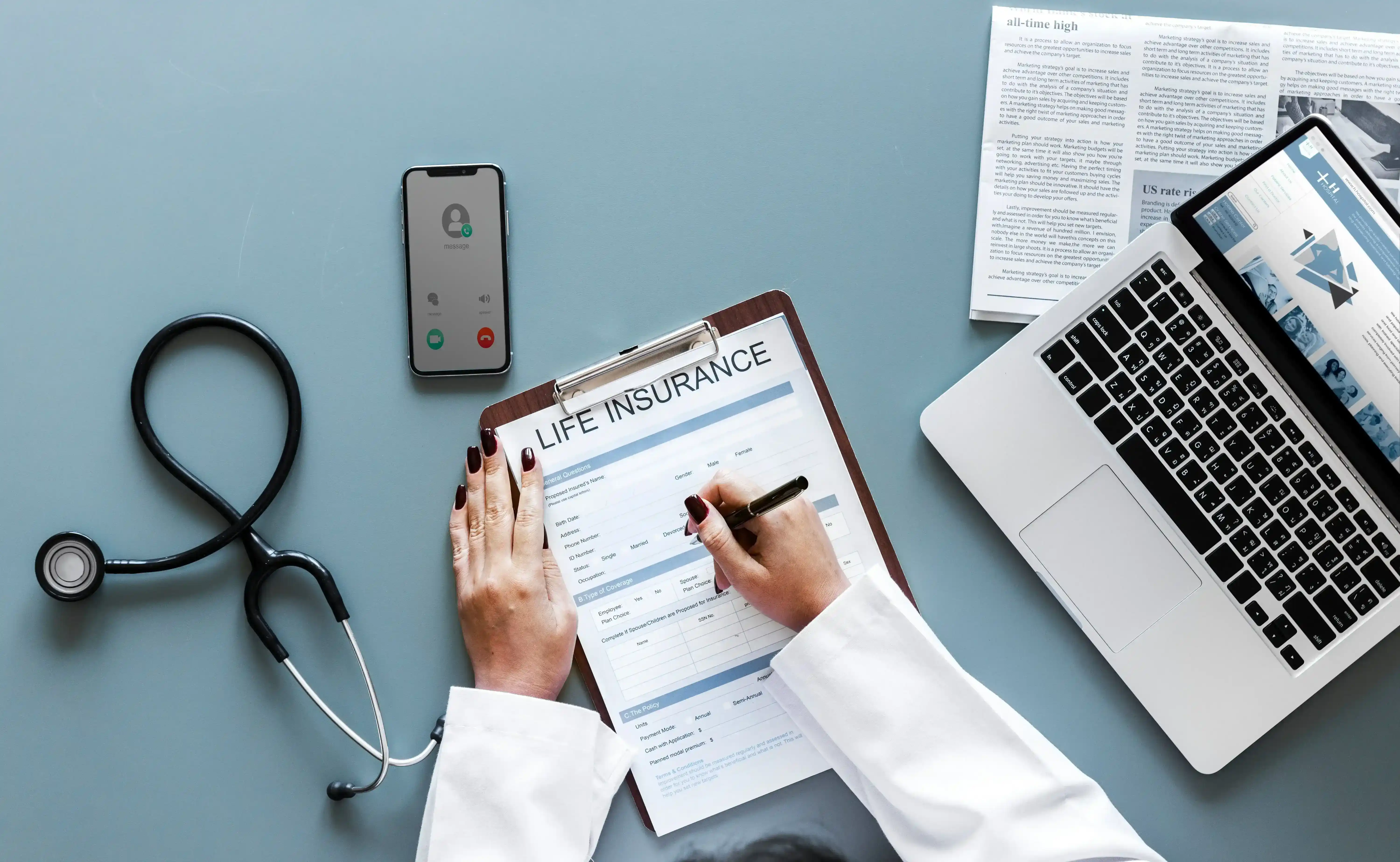 an image of a doctor filling a form next to a computer with healthcare data intelligence tools