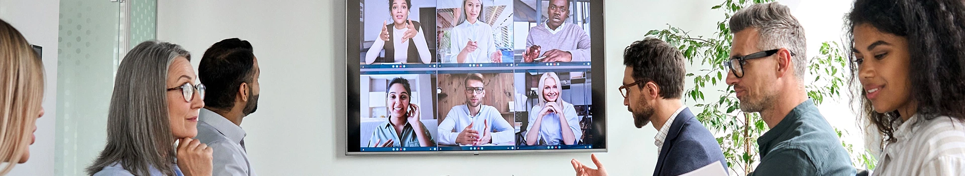 A video conference being held between several people on a big screen. These meetings can be stored and shared on an Enterprise Video Platform 