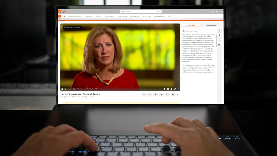 a person watching a video on laptop