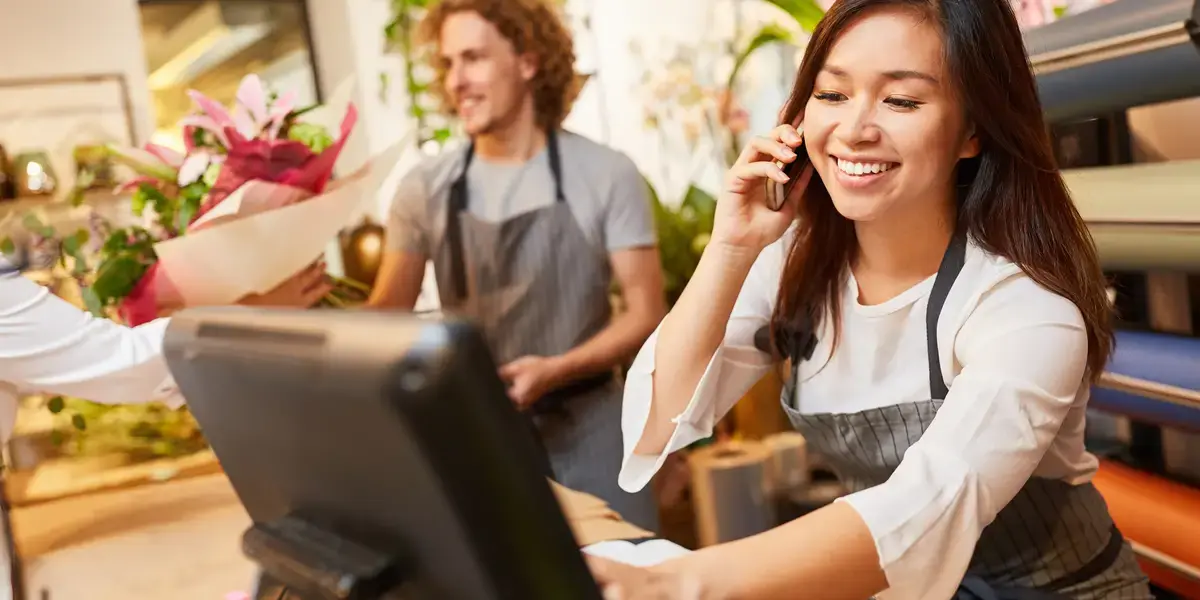 A retail staff member on her phone