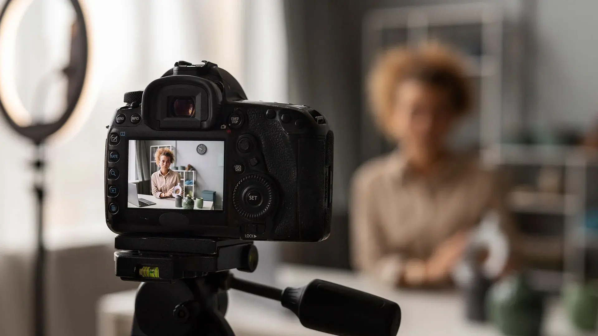 Women recording product video in front of camera
