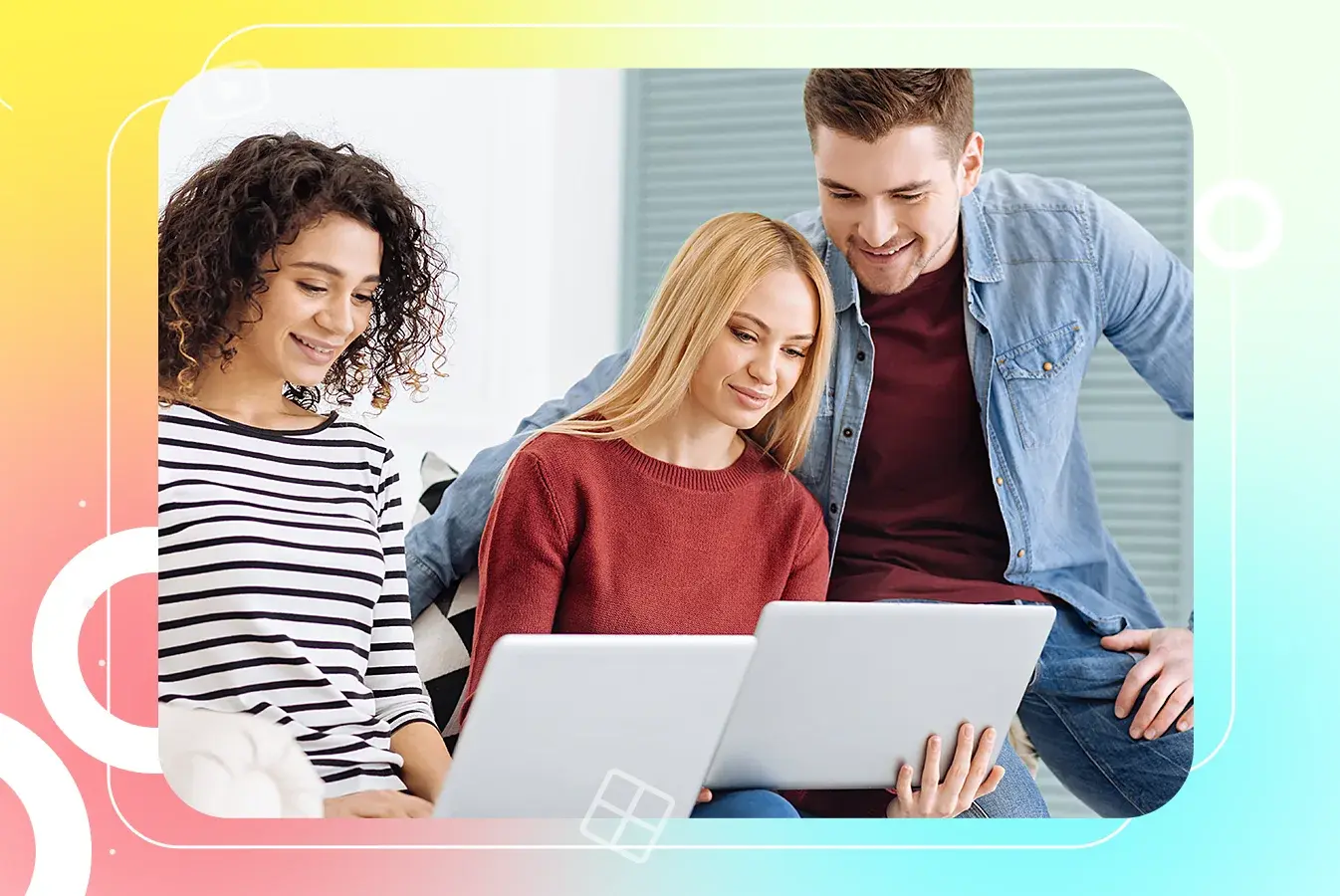 Three colleagues collaborating on a project with laptop.