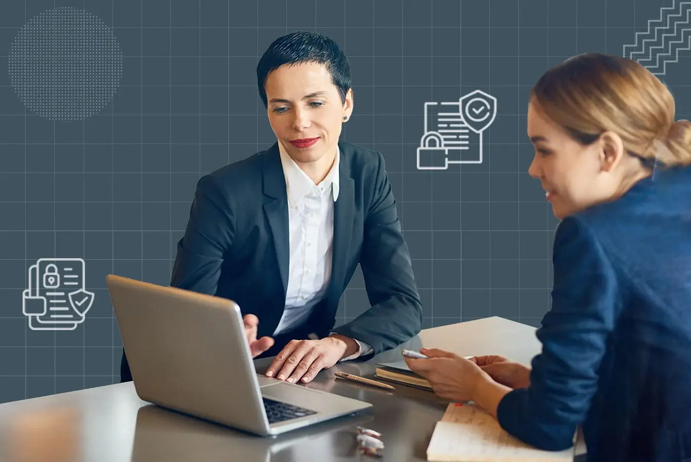 Two legal professionals working on a laptop 