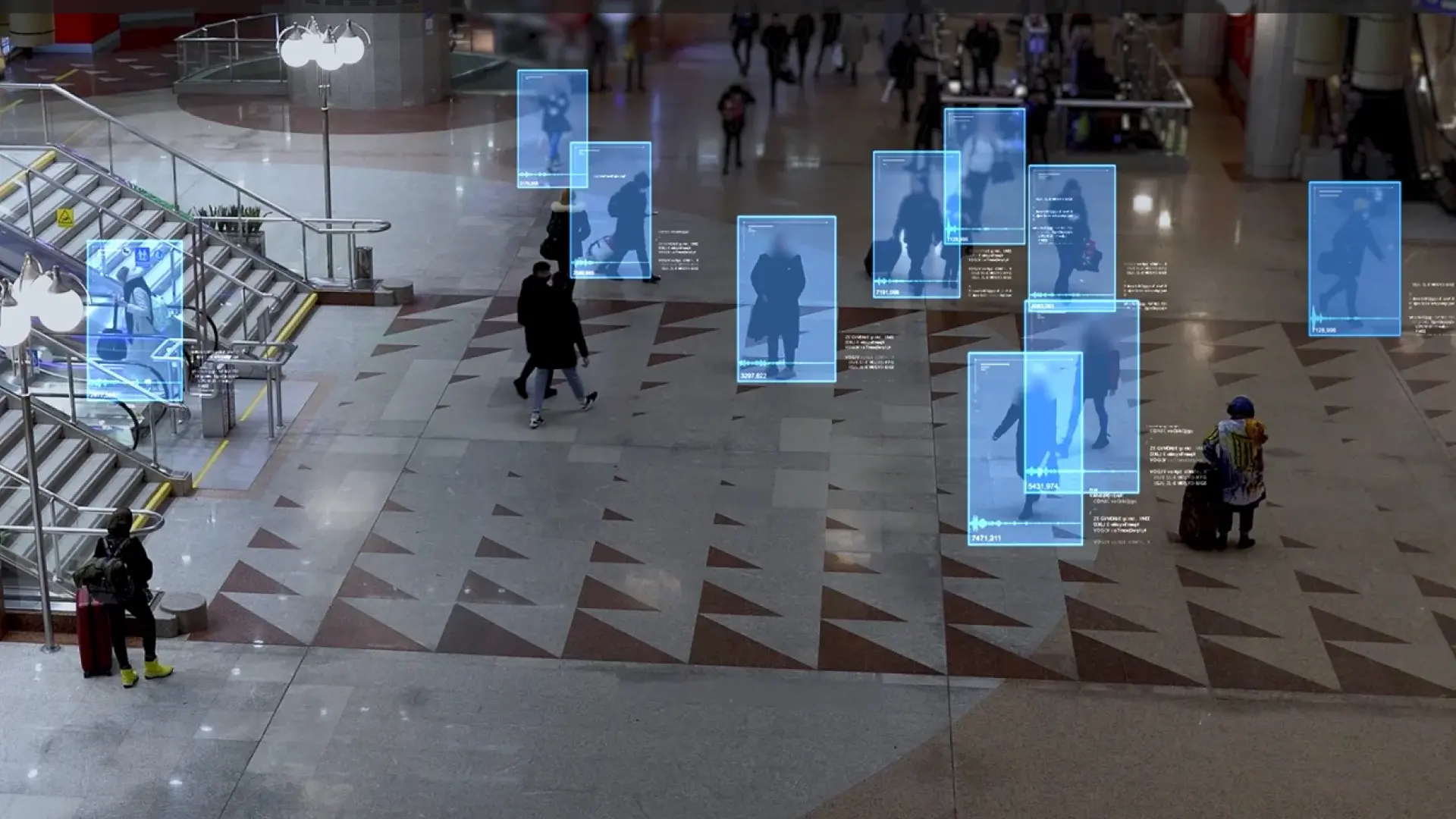 Overhead view of a crowded public space with people highlighted by blue AI surveillance tracking boxes