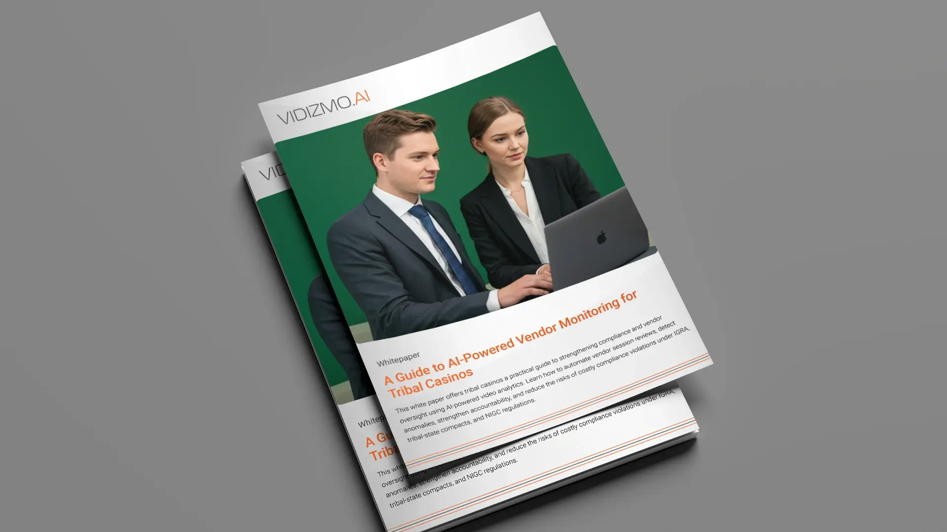 Two business professionals in formal attire review content on a laptop, featured on the cover of a VIDIZMO AI whitepaper titled 