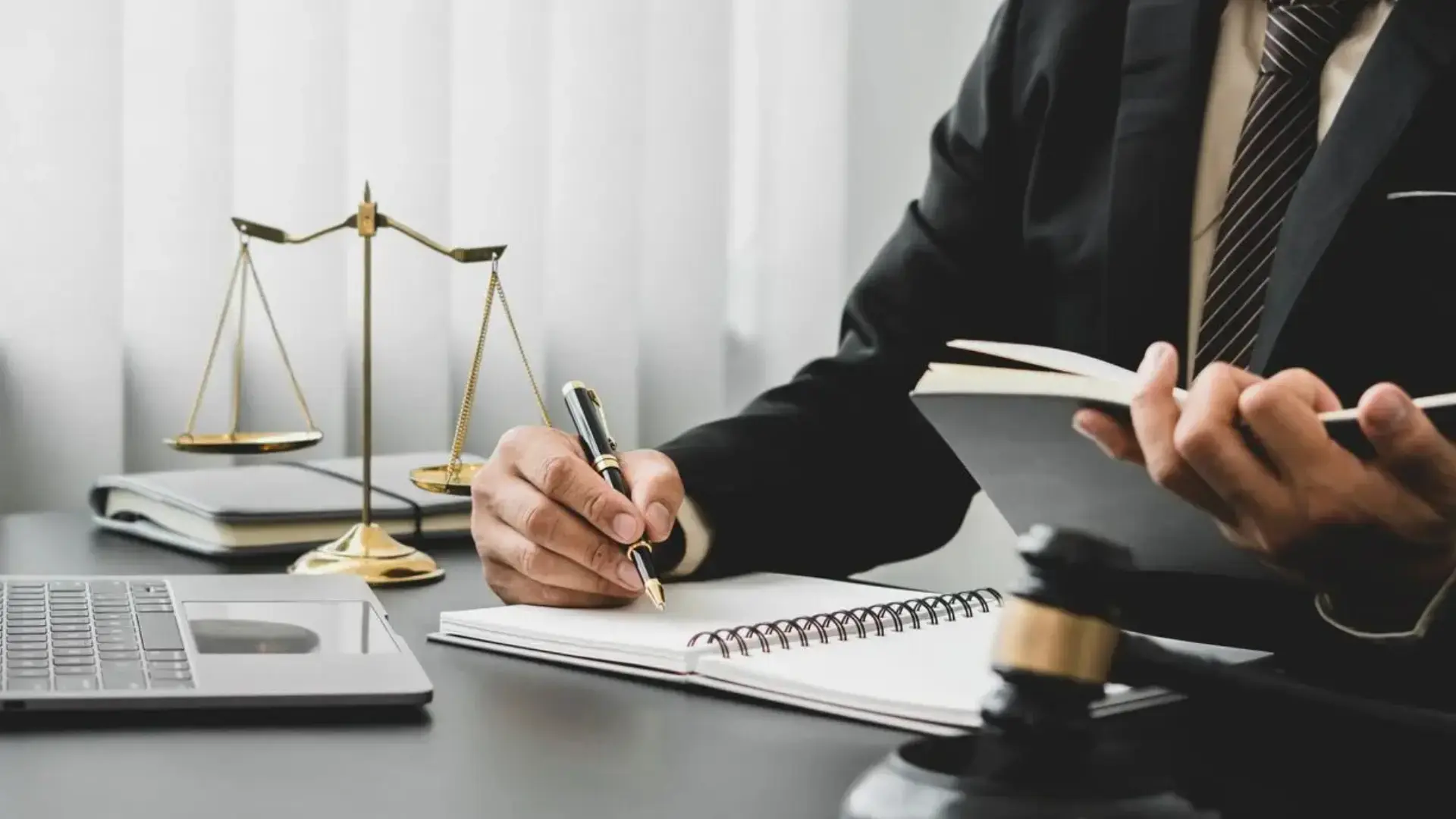 A lawyer writing something with a pen.
