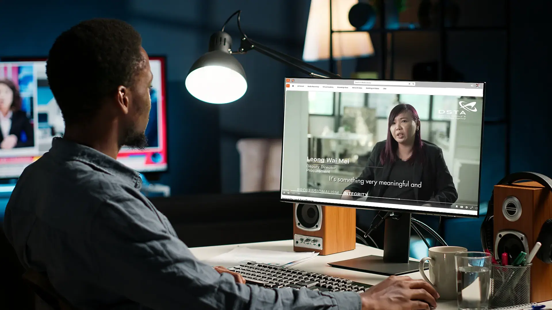 Man at desk watching enterprise video on demand example with employee testimonial on EnterpriseTube platform