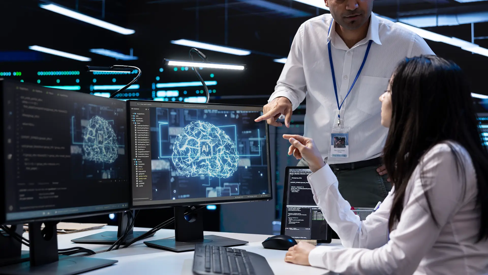 Two person working on a computer in an office settings