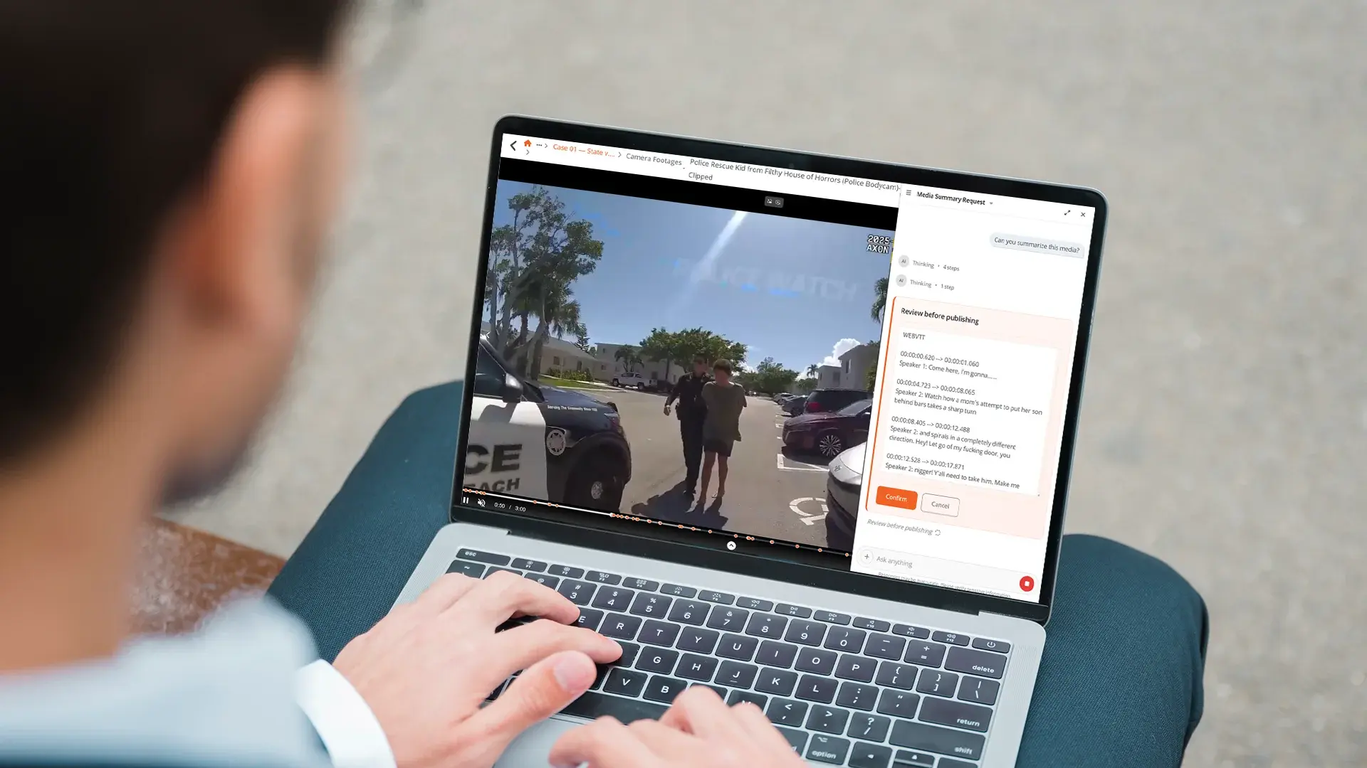 Person using a laptop to review police bodycam footage.