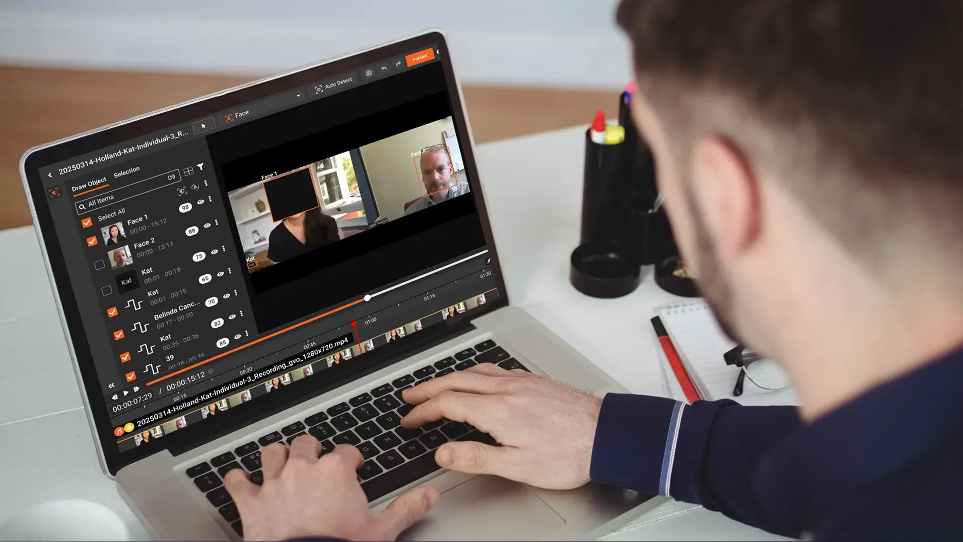a person redacting multiple faces using ai redaction