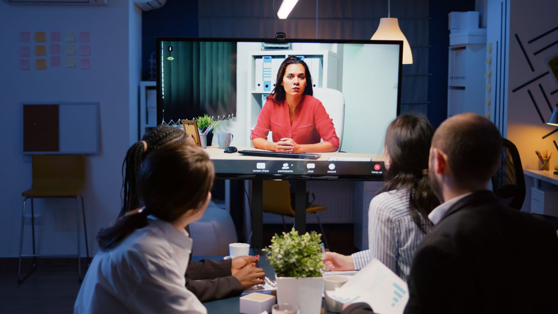 An image showing individuals in an office viewing a CLE training video lecture