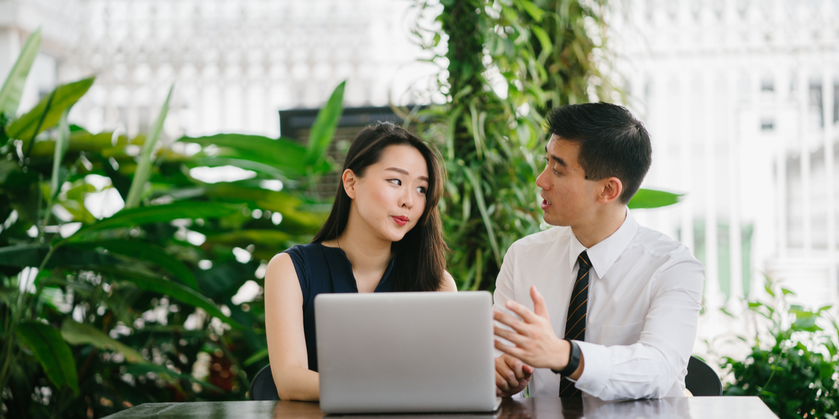 An employee helping coworker in creating a video gallery