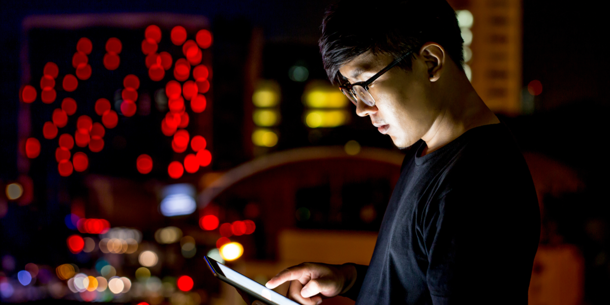 A man searching for videos on his tablet