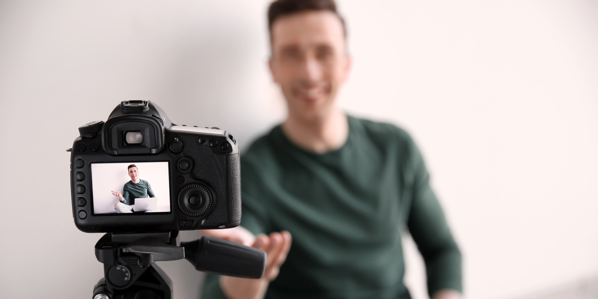A man recording a video using a video camera 