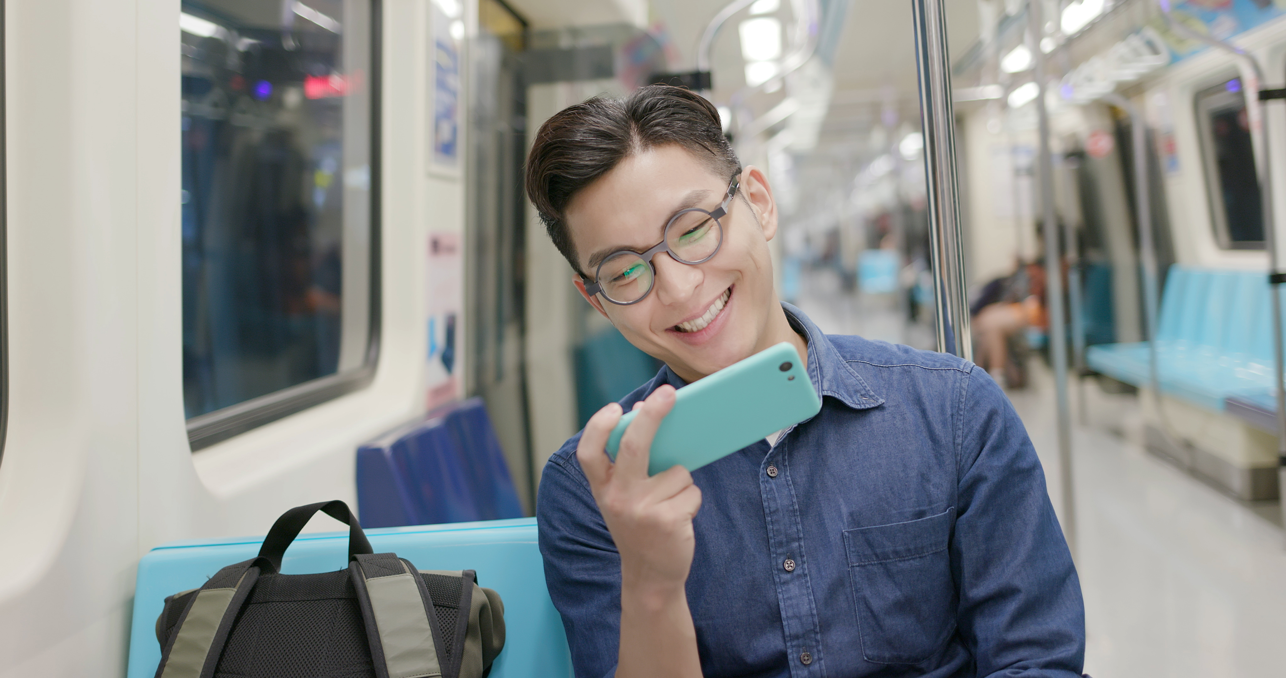 A person watching a training video in the subway train