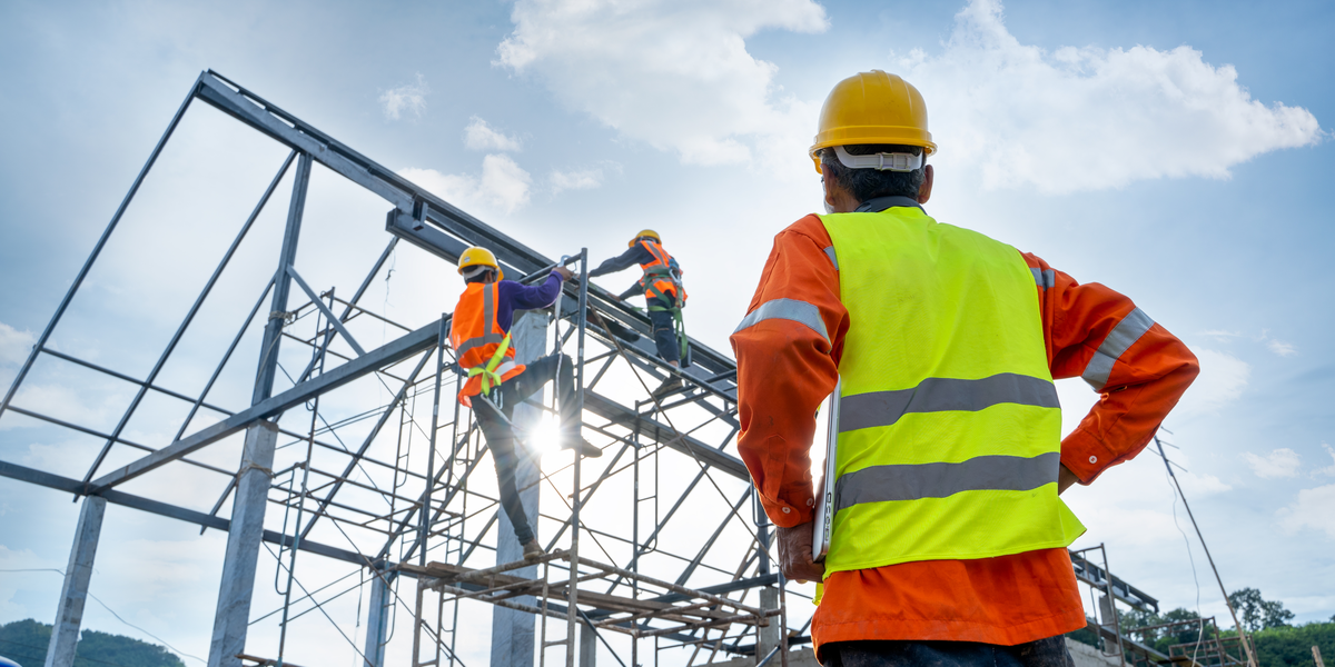 Construction workers working a building structure