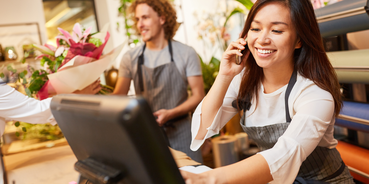 A retail staff member on her phone