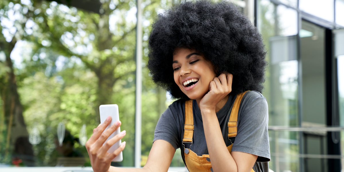 A woman watching a company video and smiling