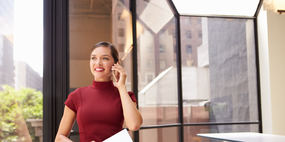 A woman on a phone in the office