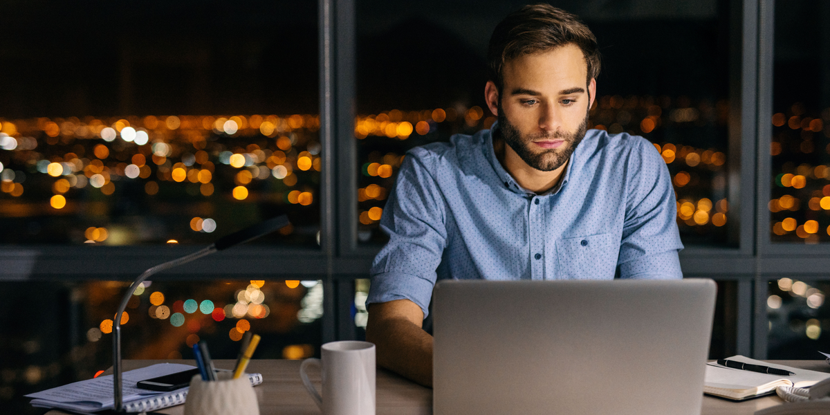 A person using a laptop at night