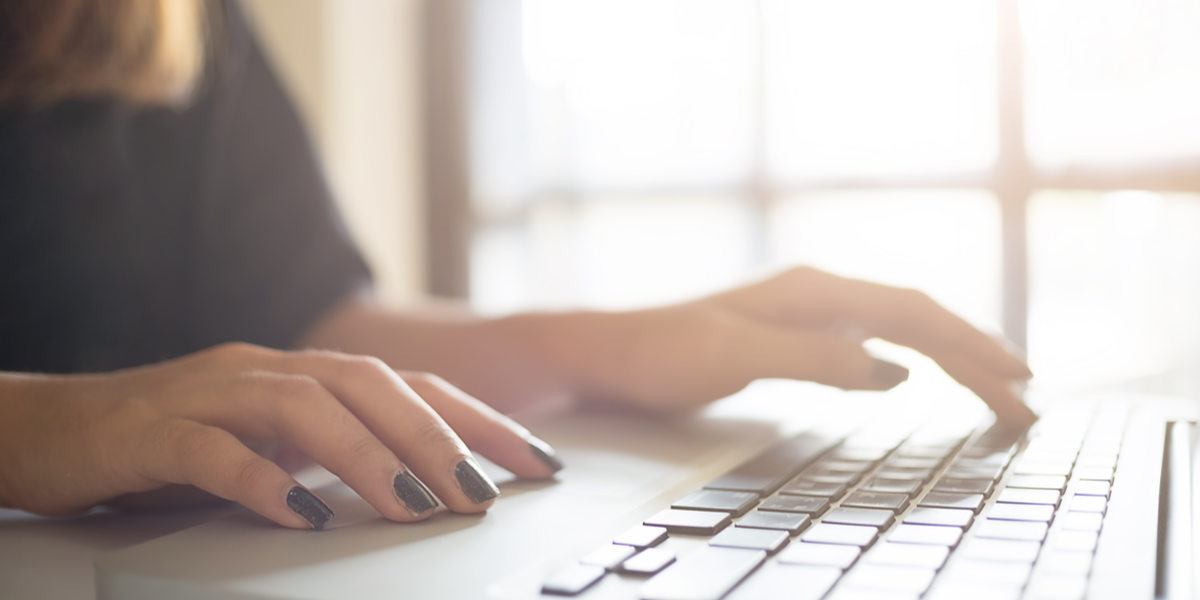 A woman searching for videos on her laptop